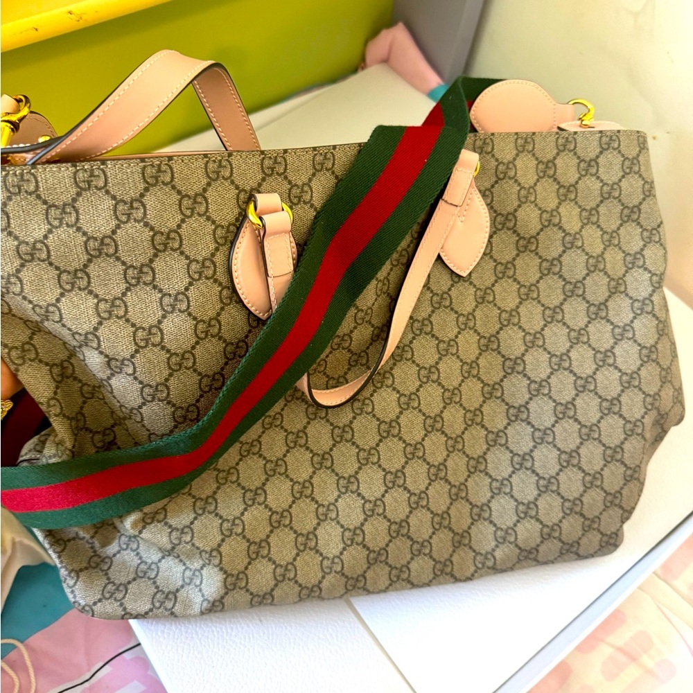Gucci bag brand new. May use for baby bag. Comes with diaper change pad.